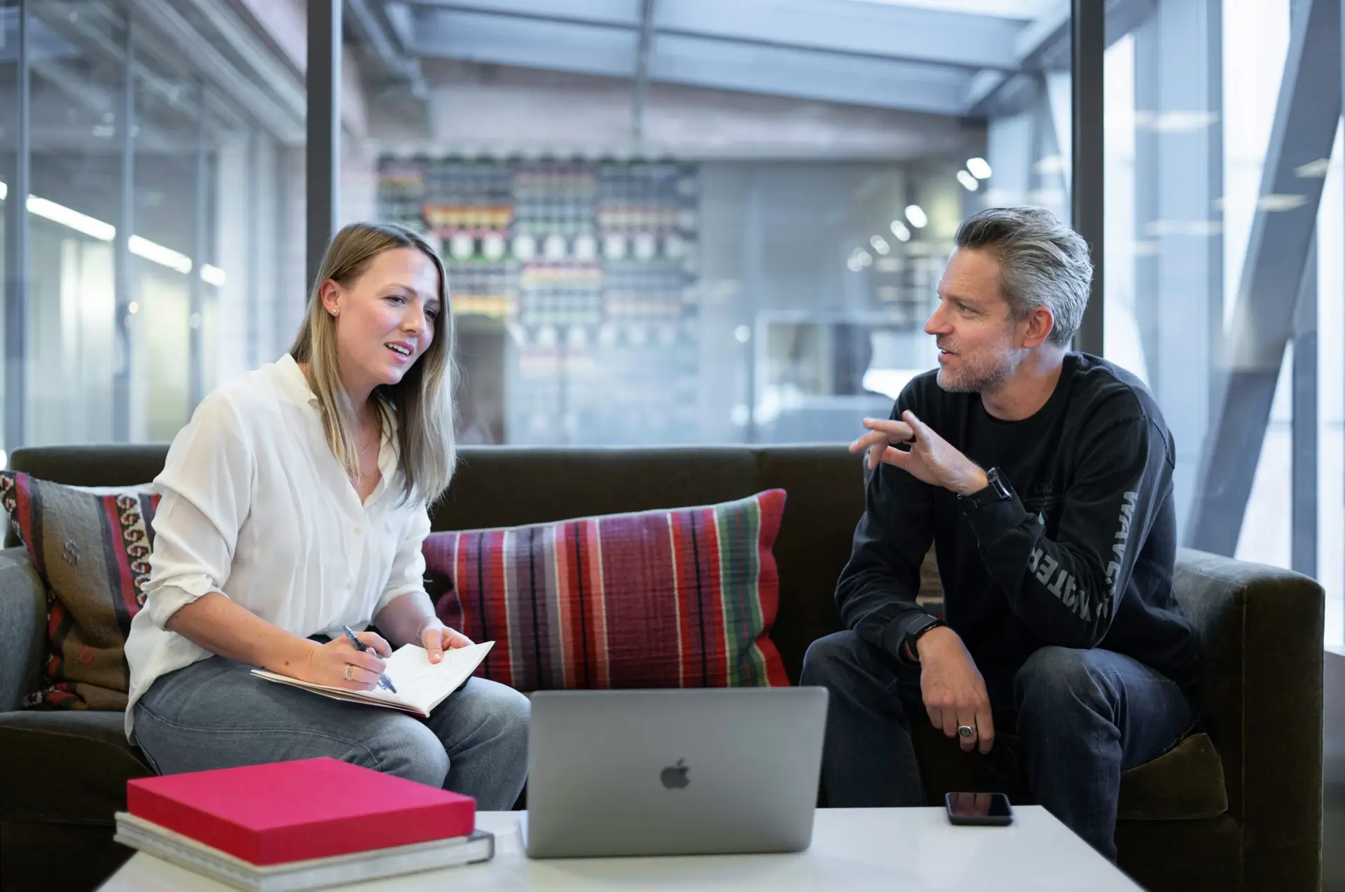 Woman and man meeting face to face in front of a laptop